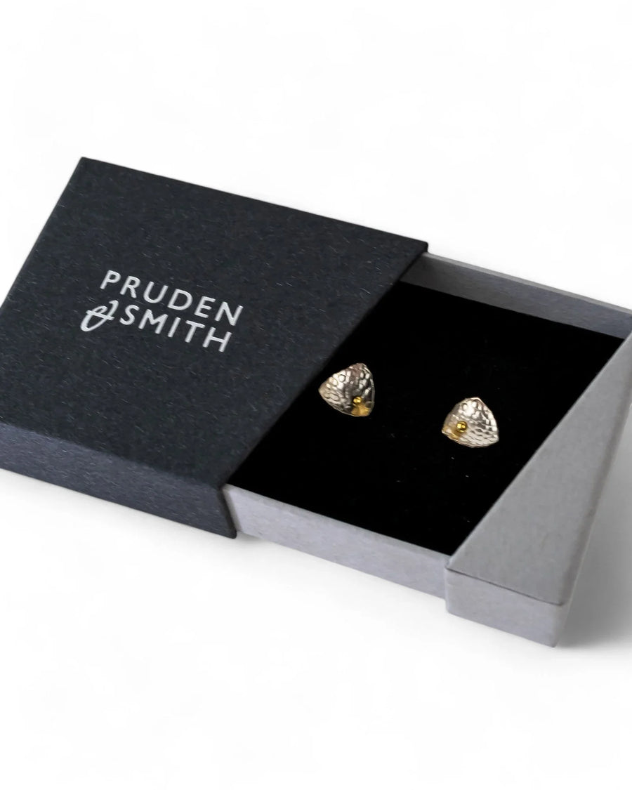 Silver and gold beaded stud earrings in a black gift box.
