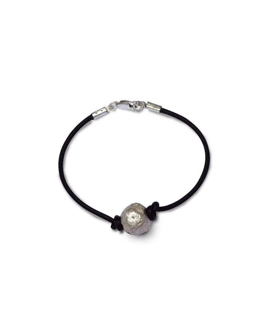 Handmade bracelet with a textured silver bead on a black faux leather cord, minimalist design