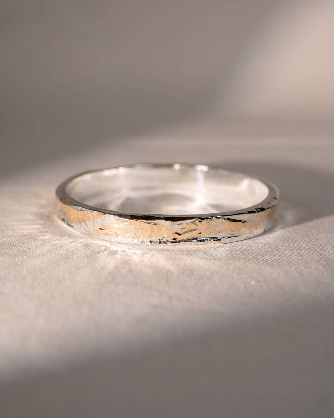 Silver and gold hammered bangle.