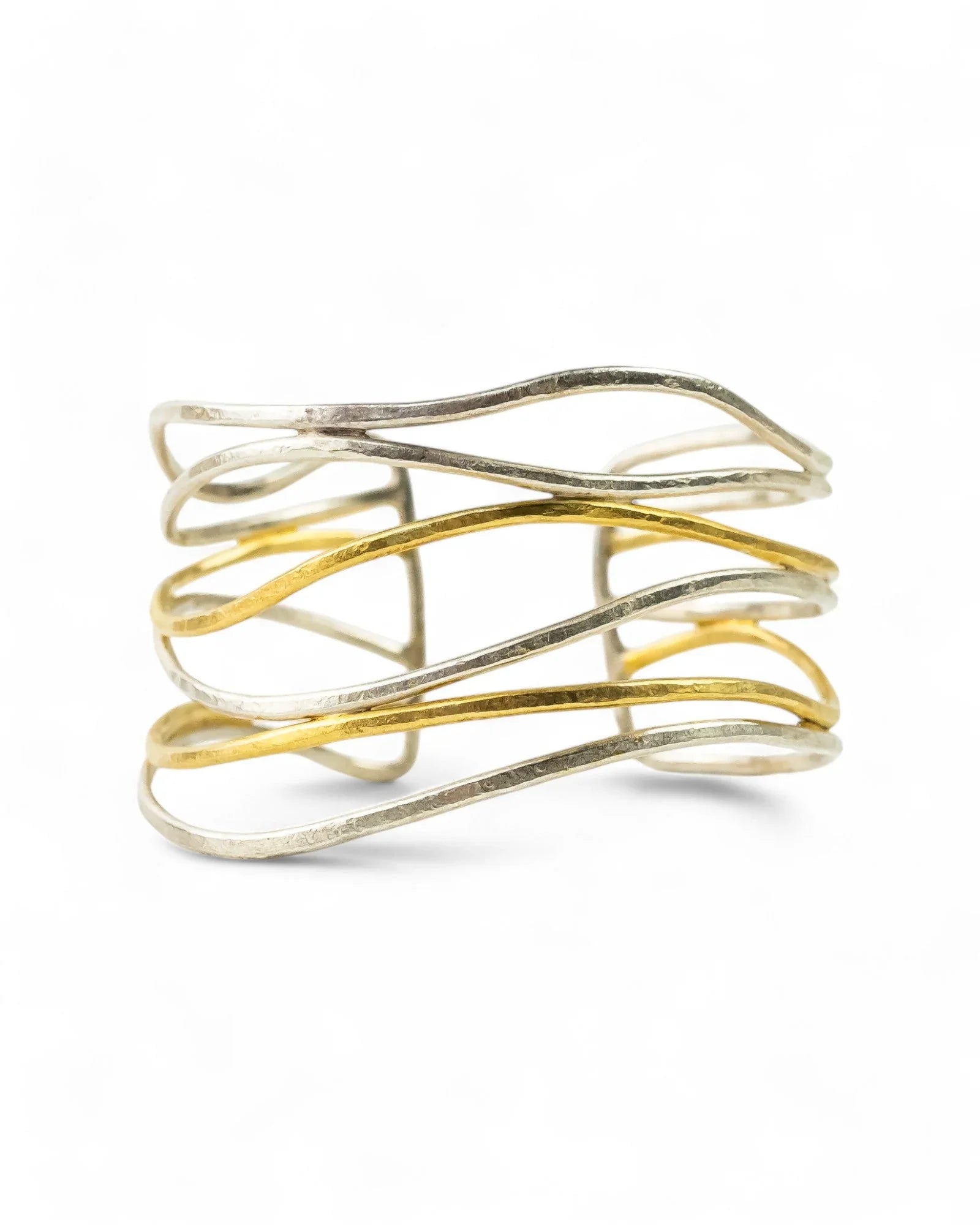 Six-strand cuff bangle with intertwined silver and gold bands, handcrafted jewelry