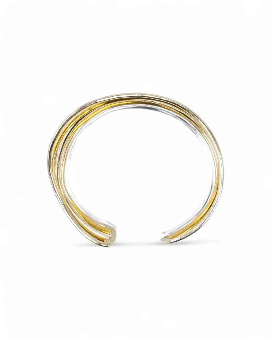 six strand silver and gold cuff bangle with a twisted, open design on white background