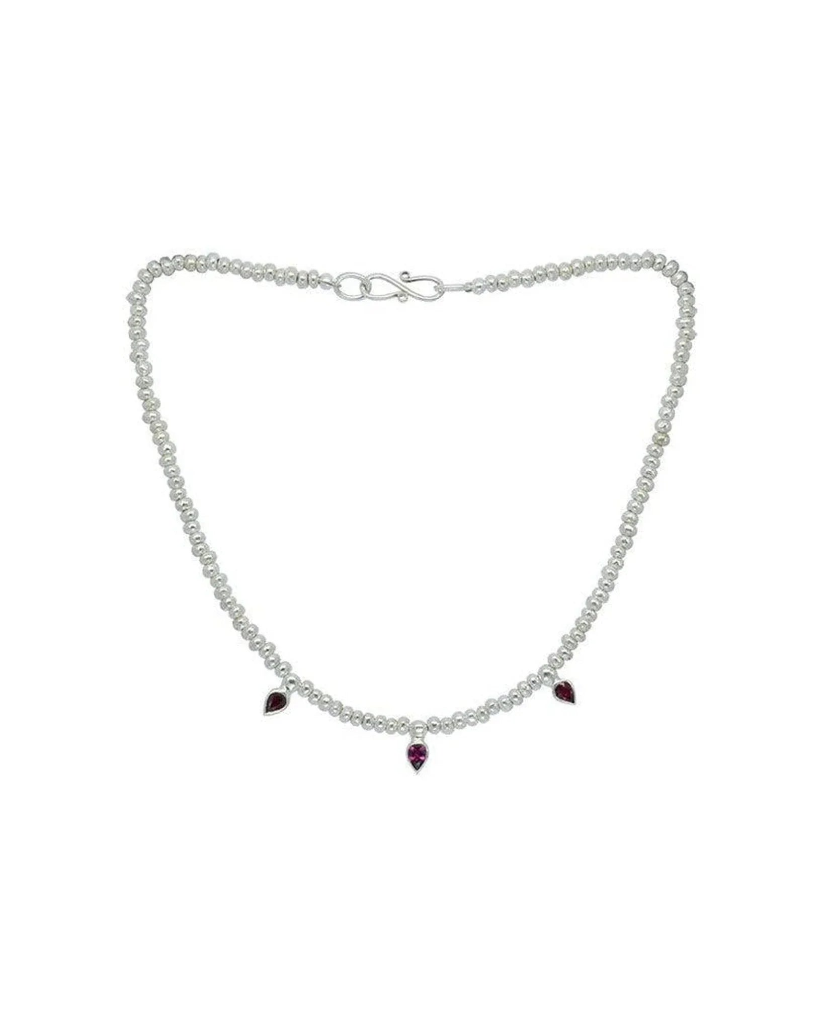 Silver nugget bead necklace with three teardrop ruby gemstone pendants on white background