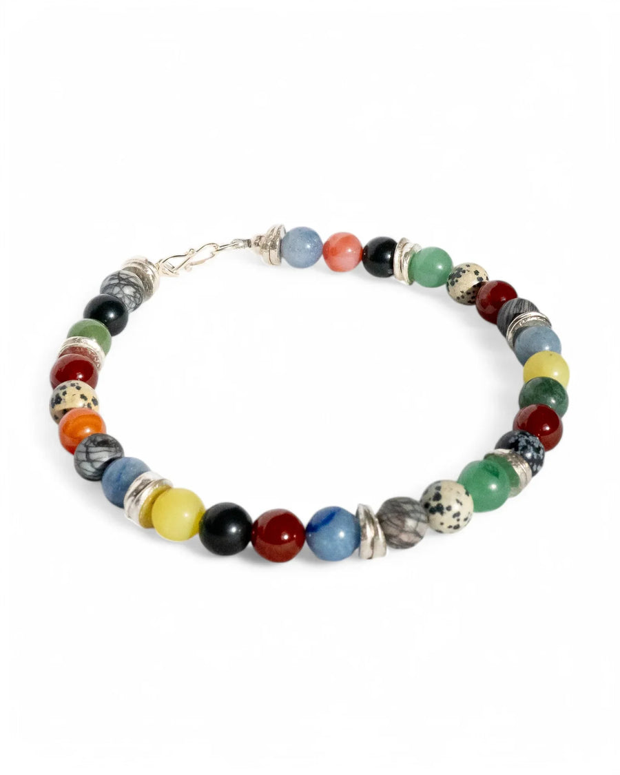 Handmade beaded bracelet with multicoloured gemstones and silver accents on white background