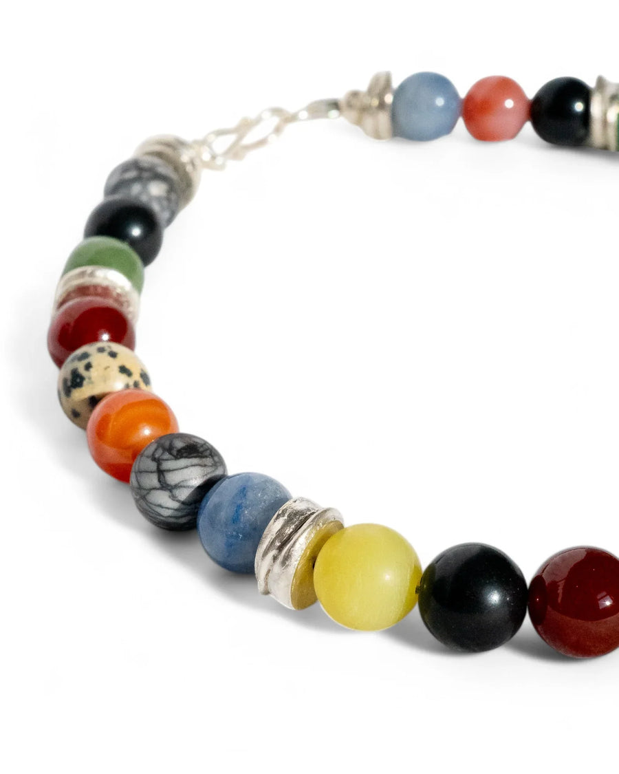 Handmade colourful gemstone beaded necklace with silver accents on white background