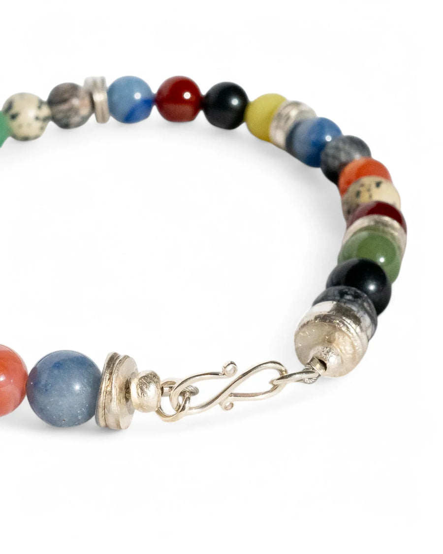 Handmade multicolour gemstone beaded bracelet with silver clasp on white background