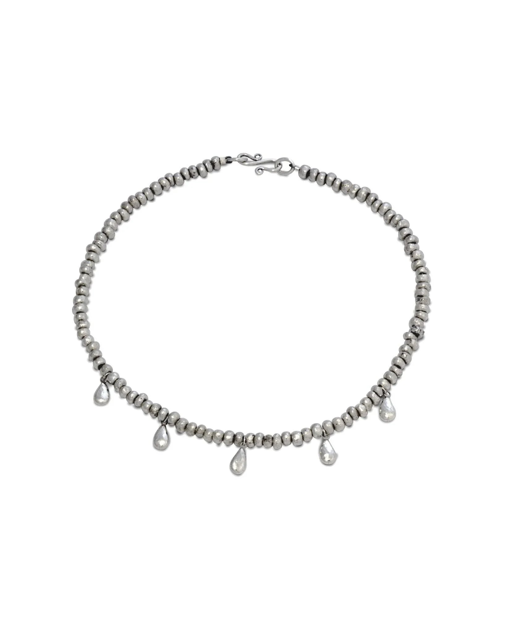 Silver nugget necklace with hammered teardrop charms, handcrafted jewelry on white background