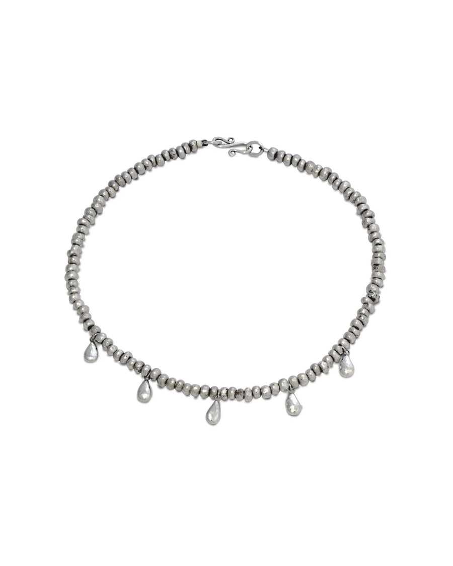 Silver nugget necklace with hammered teardrop charms, handcrafted jewelry on white background