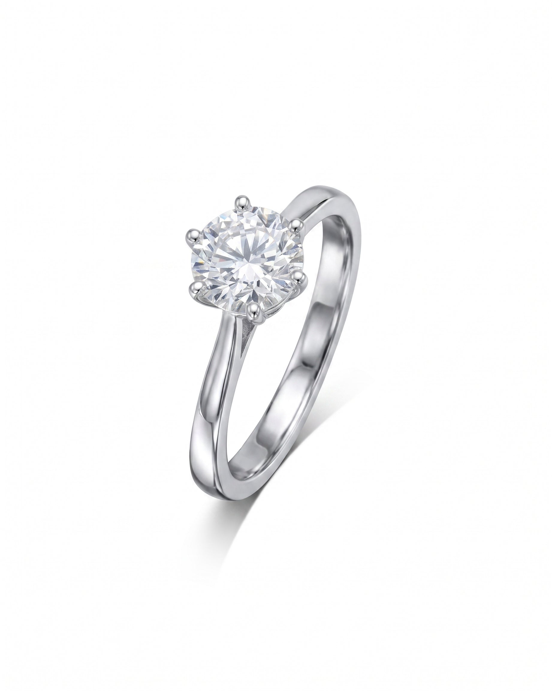 Platinum engagement ring featuring a round brilliant-cut diamond held in a classic six-claw setting.