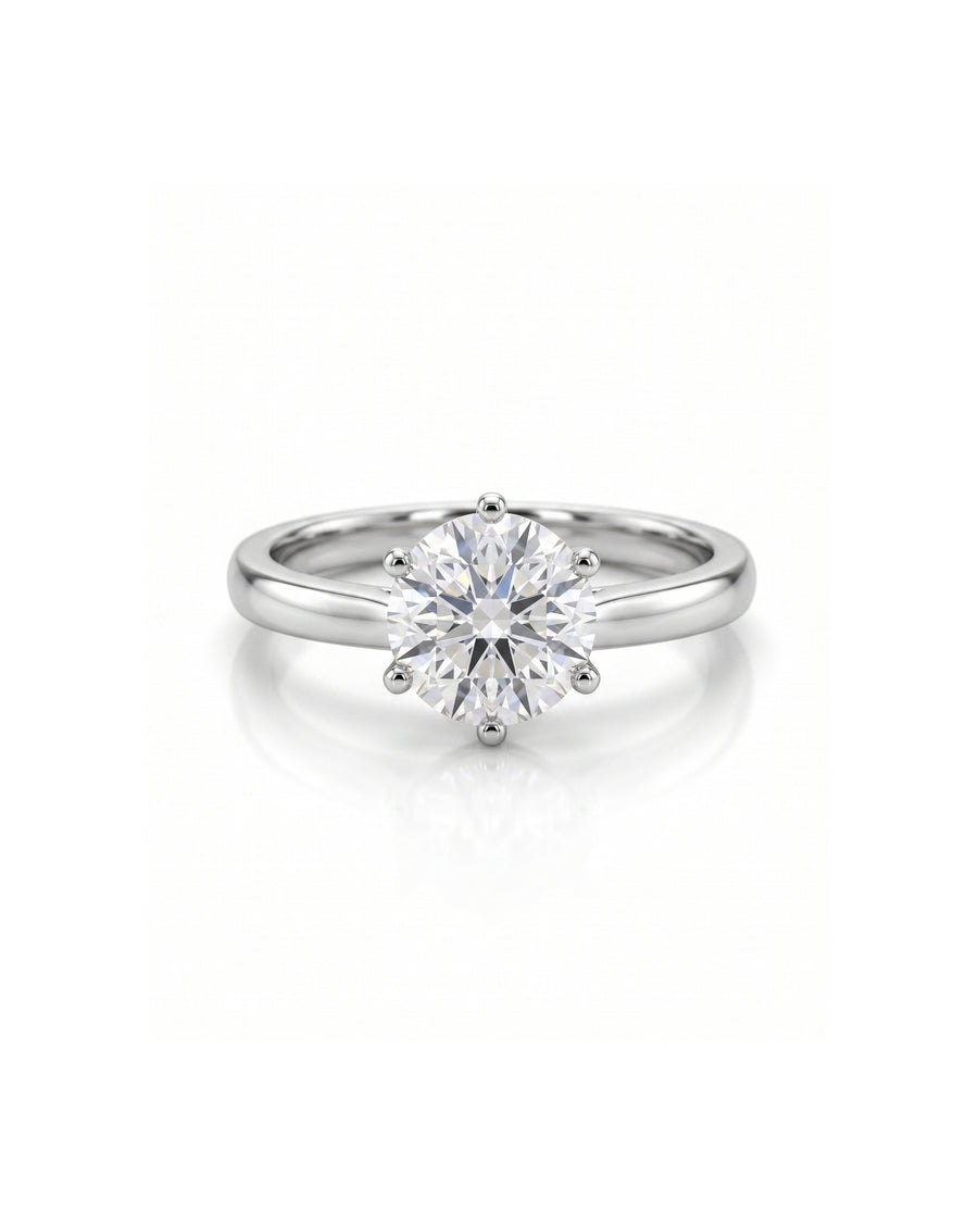 Platinum engagement ring with a round diamond in a six-claw setting.