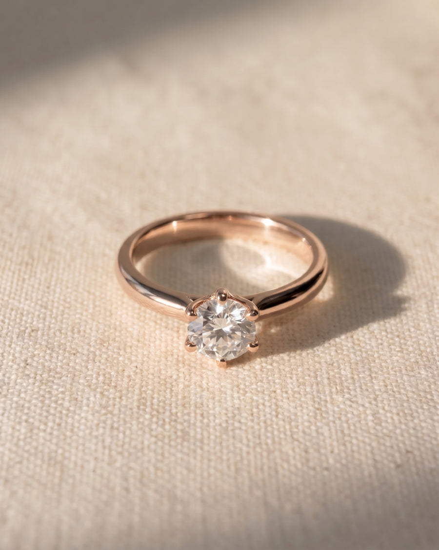 Rose gold six claw solitaire engagement ring with a round diamond.