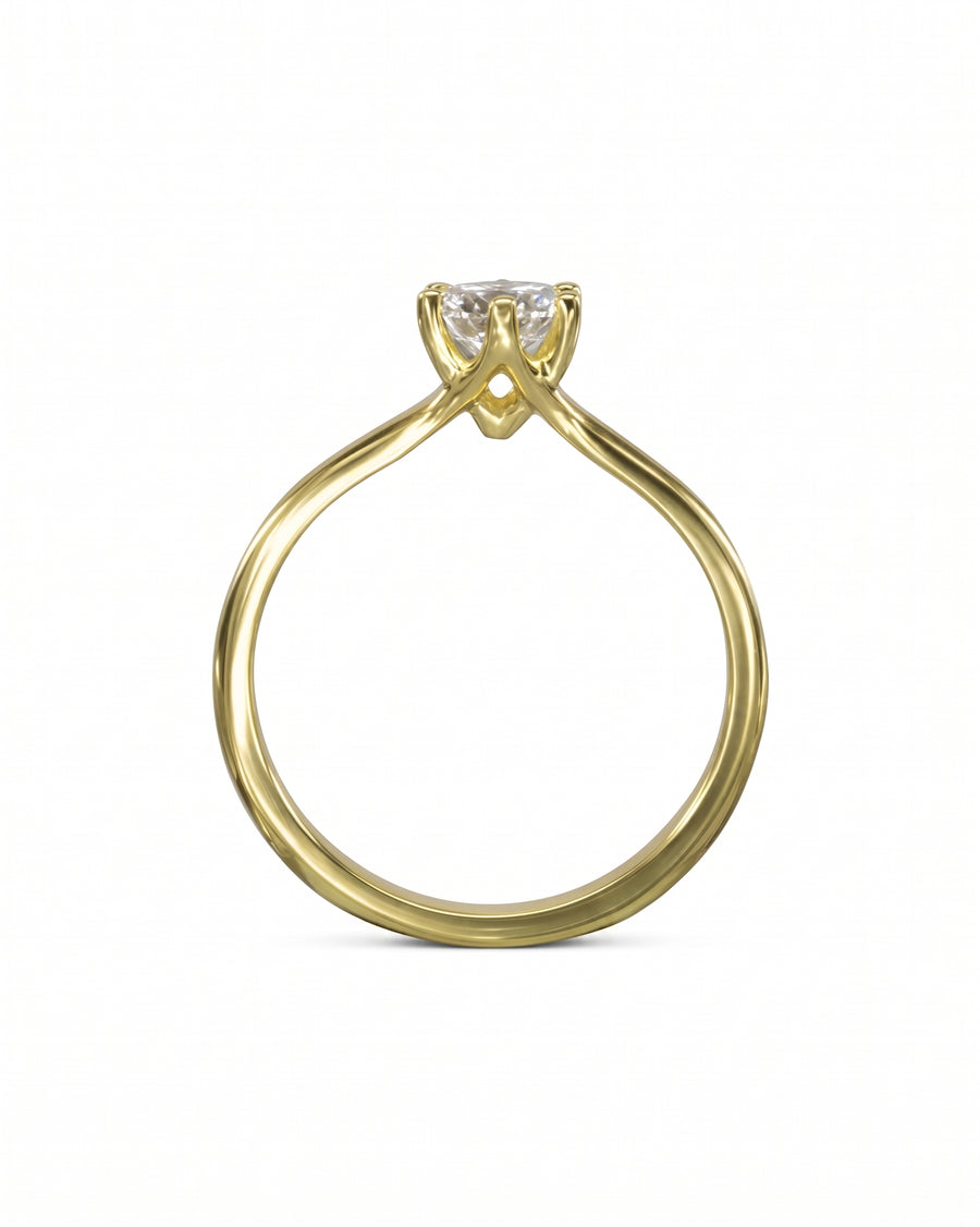Gold six claw solitaire engagement ring with a round diamond.