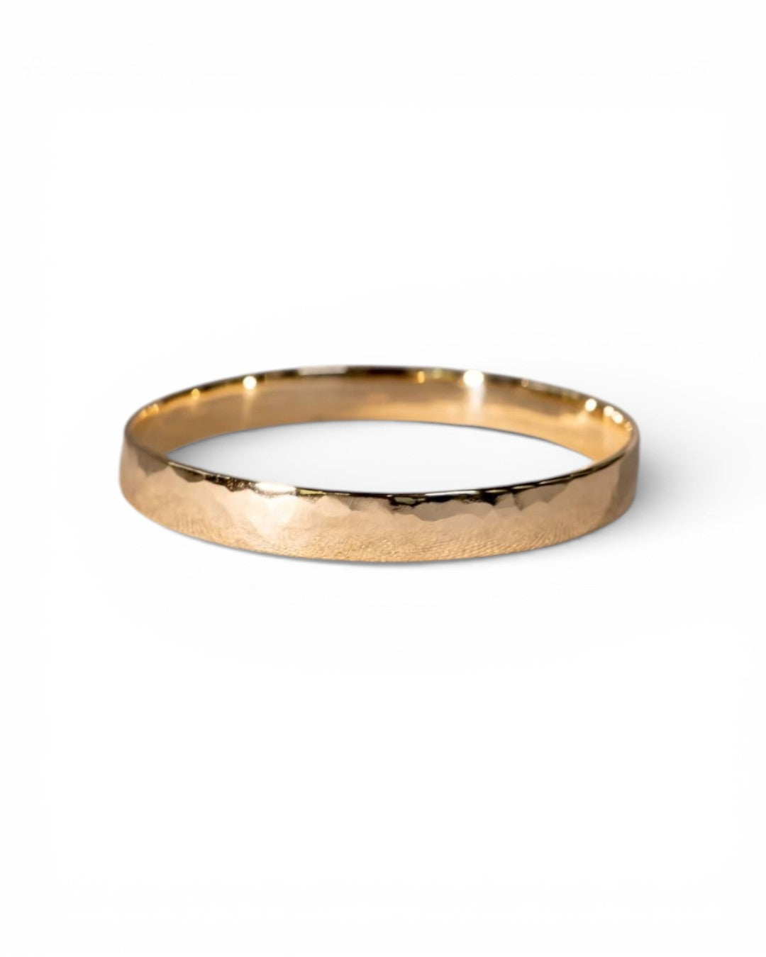 Solid 9ct yellow gold bangle with a hammered texture on a white background