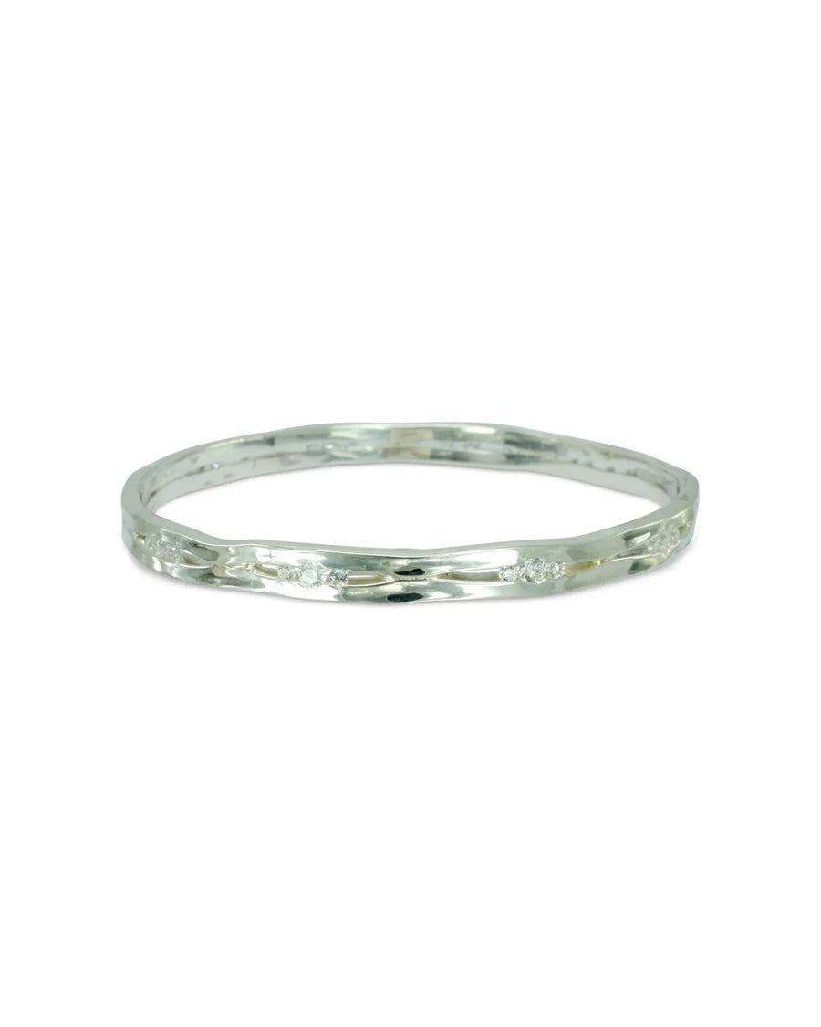 Solid silver and diamond bangle with a wavy, textured design.