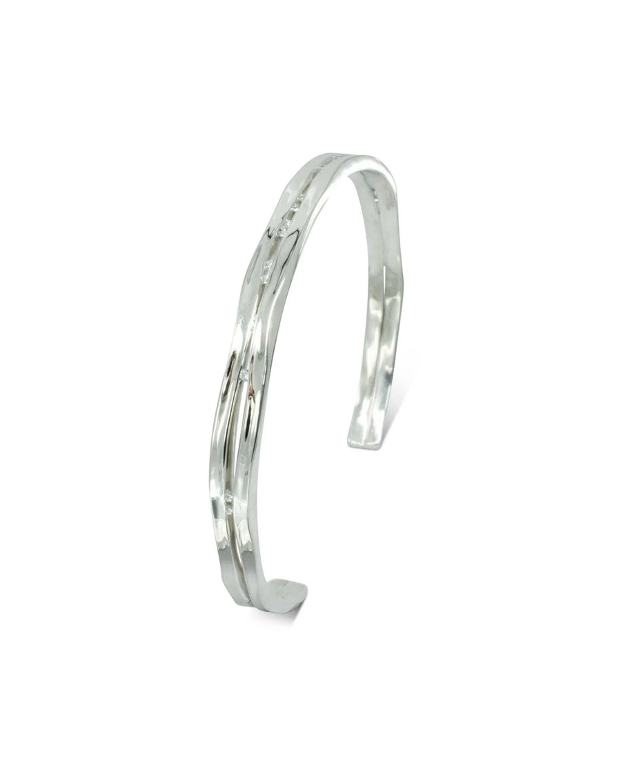 Solid silver and diamond bangle with a wavy, open cuff design.
