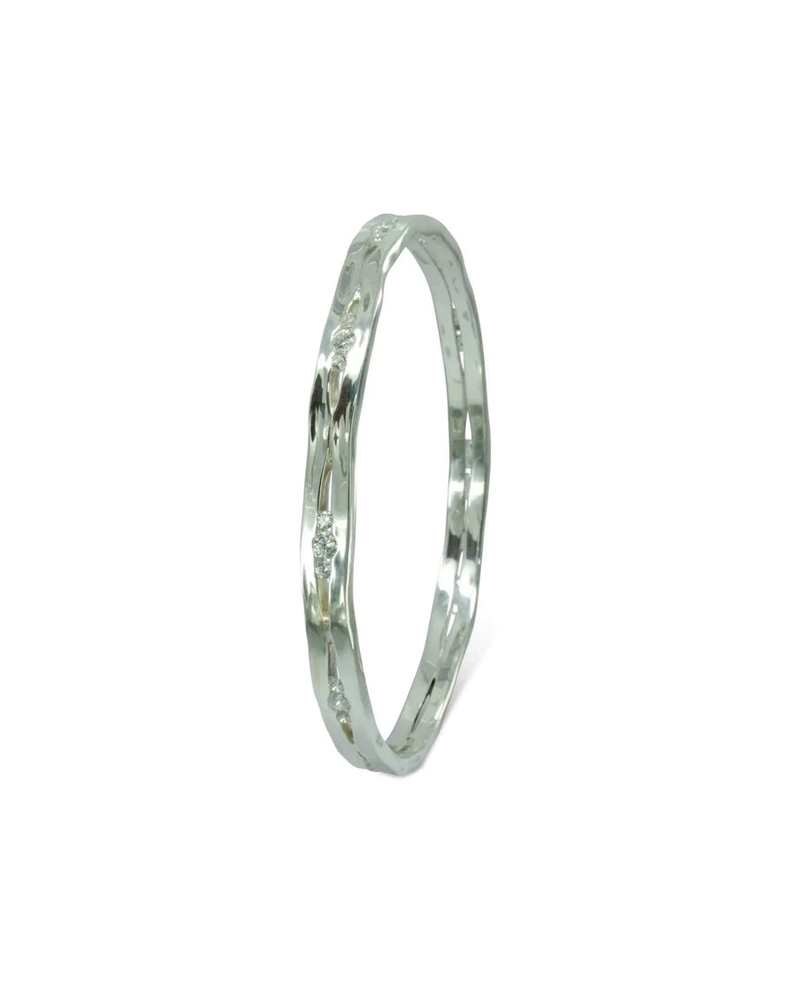 Solid silver bangle with natural diamonds and a wavy design.