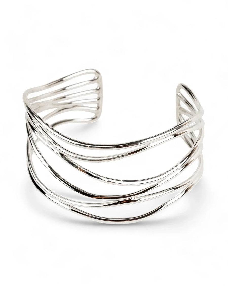 Six strand solid silver cuff bangle with open, layered design on white background