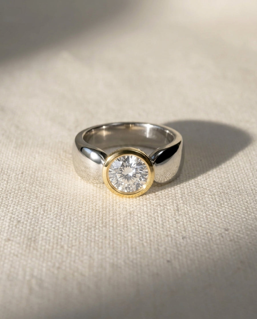 Platinum and 18ct yellow gold two-tone engagement ring with a 1ct round solitaire diamond.