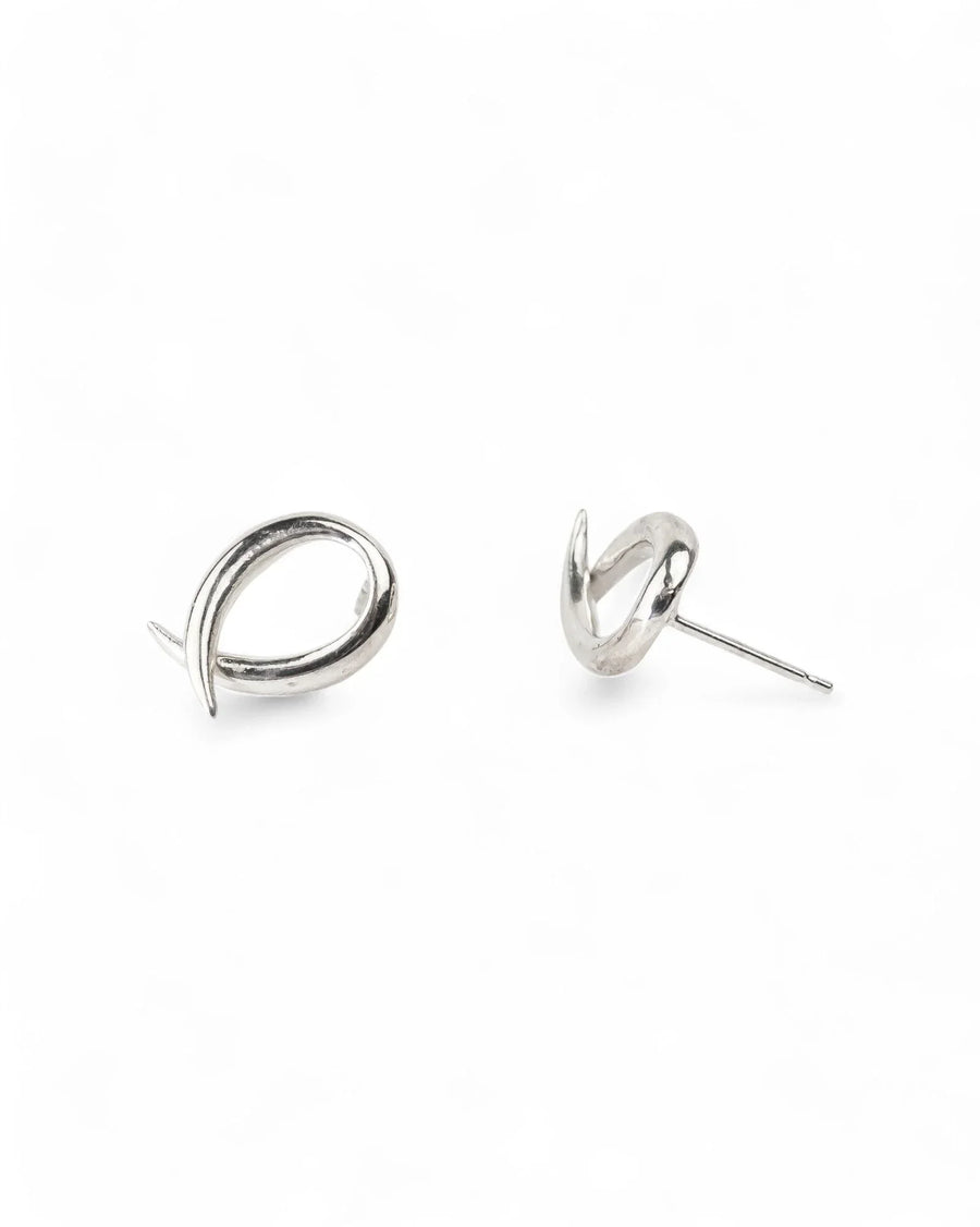 Spiky crossover silver stud earrings with modern, organic design on white background