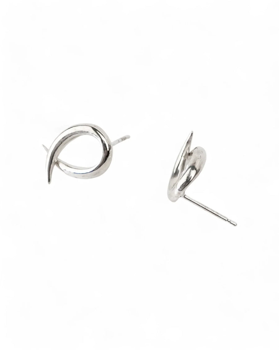 Handmade silver stud earrings with spiky, crossover design on white background
