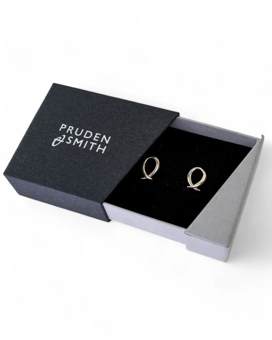 silver crossover stud earrings with spiky design in a black gift box