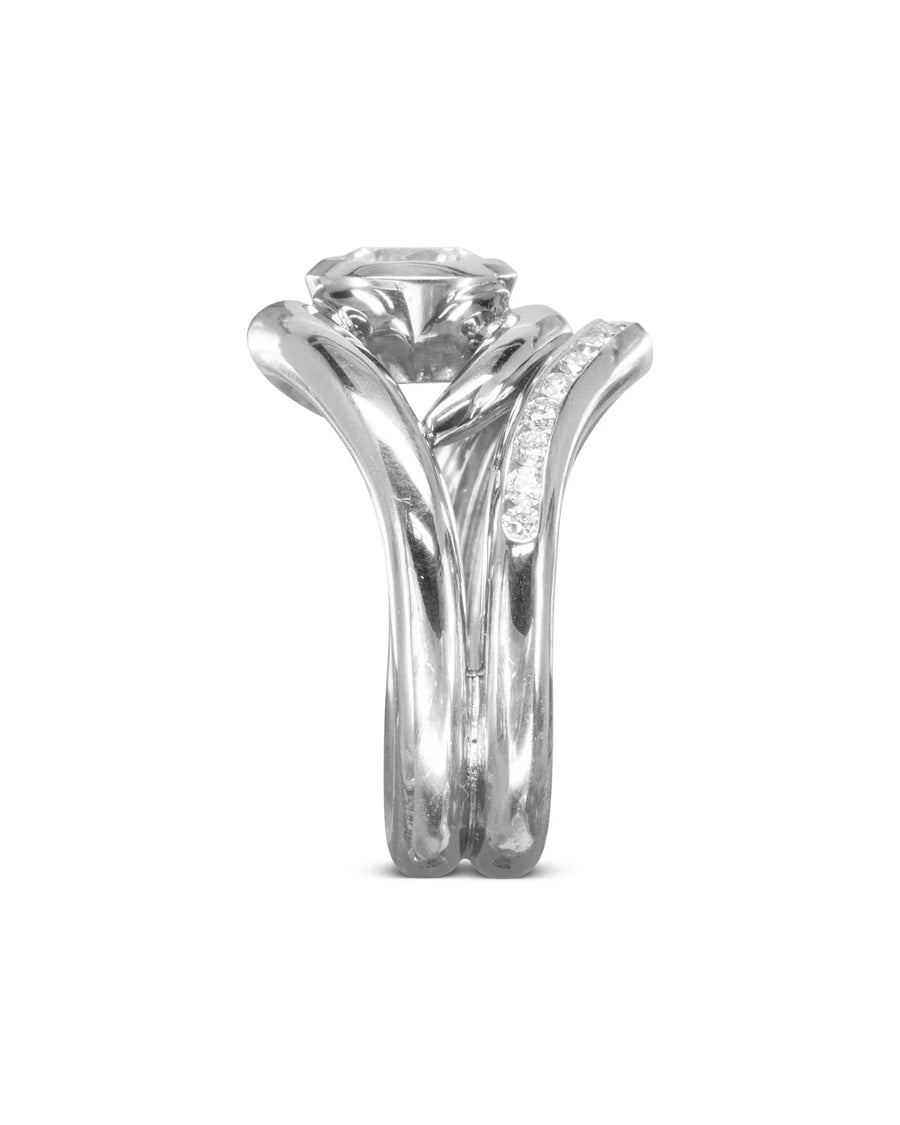 Silver spiky engagement and diamond shaped wedding band set.