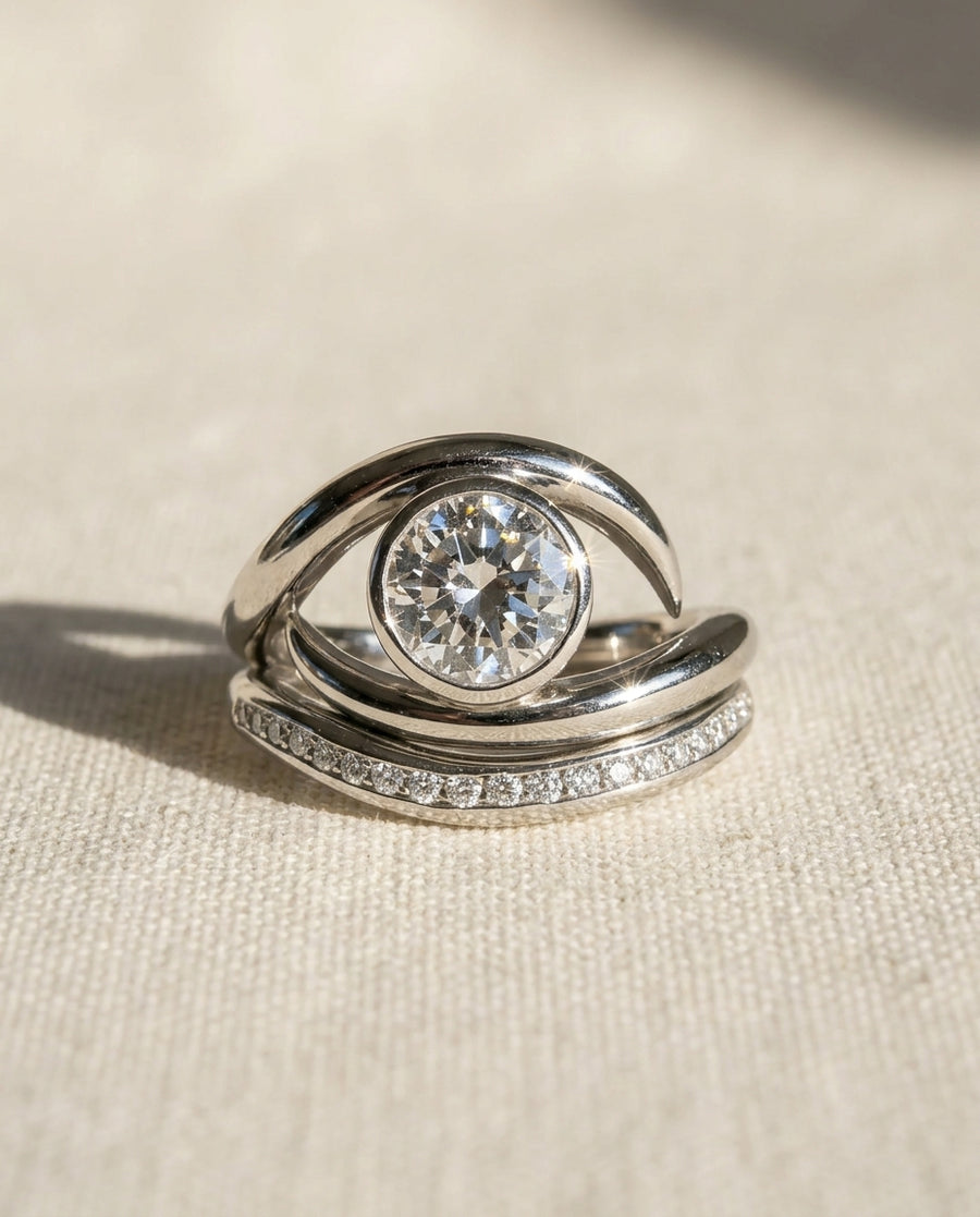 Platinum engagement ring with 0.5ct diamond and curved wedding band with pave diamonds.