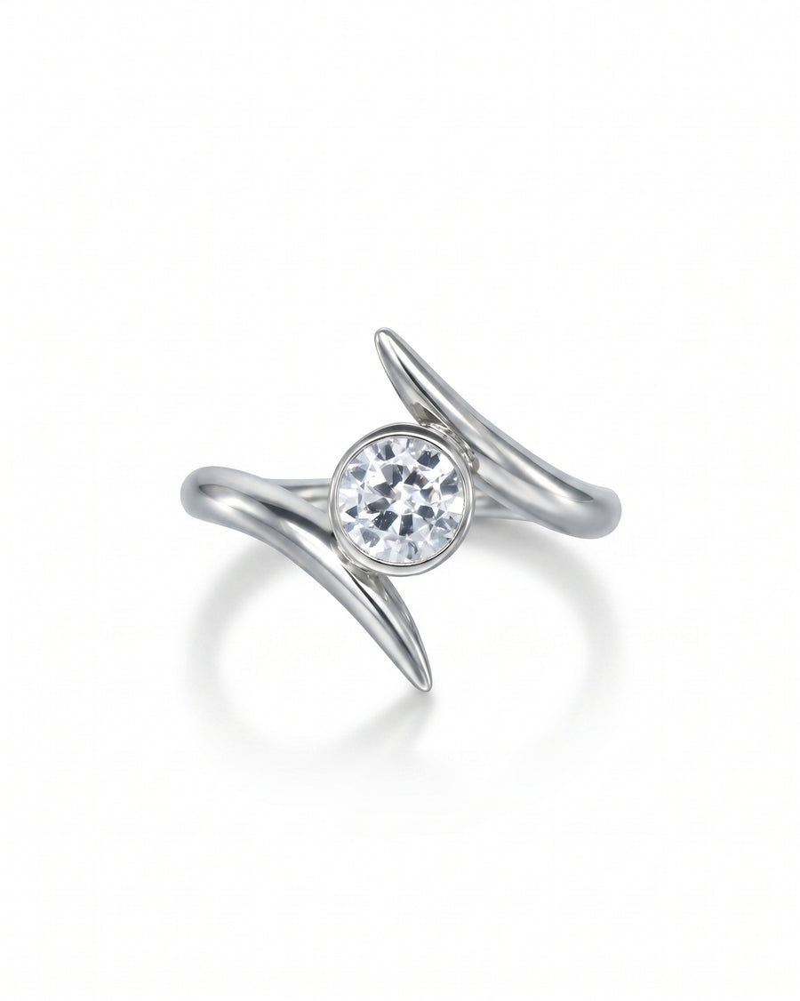 Silver spiky engagement ring with a round clear gemstone.