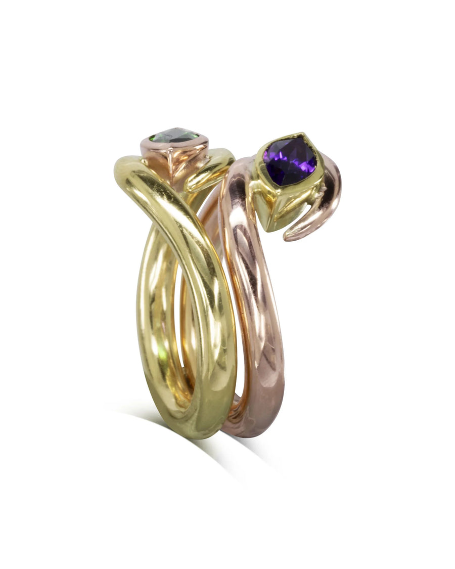 Gold and rose gold stacking rings with green and purple gemstones.