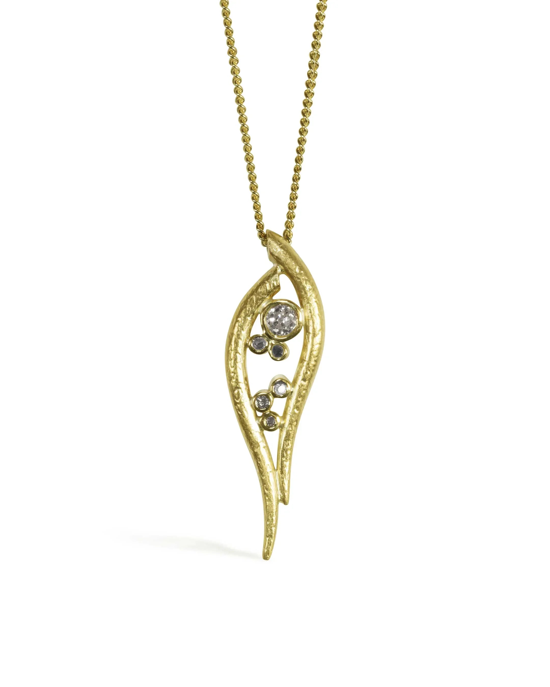 organic hammered gold pendant necklace with diamonds on a gold chain