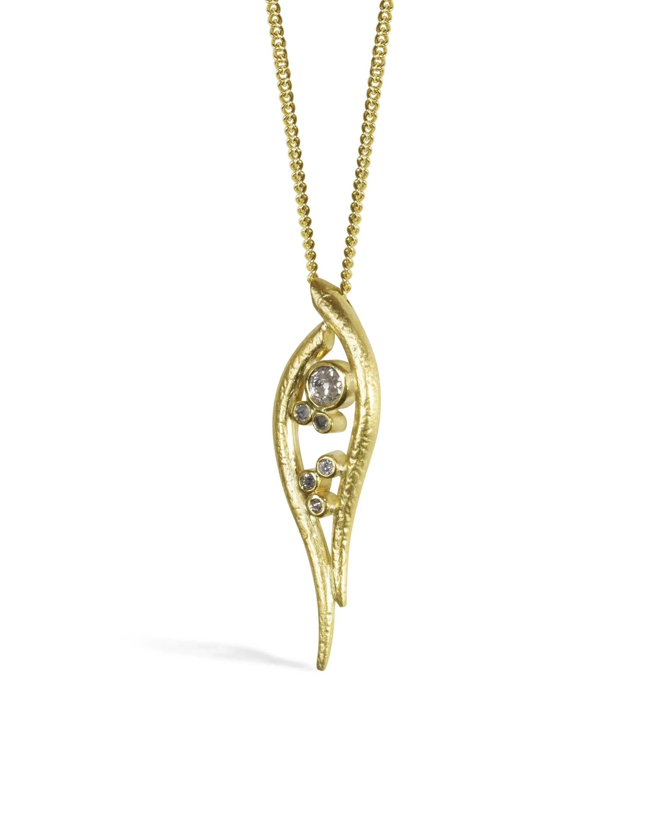 Organic hammered gold pendant necklace with diamonds on a gold chain