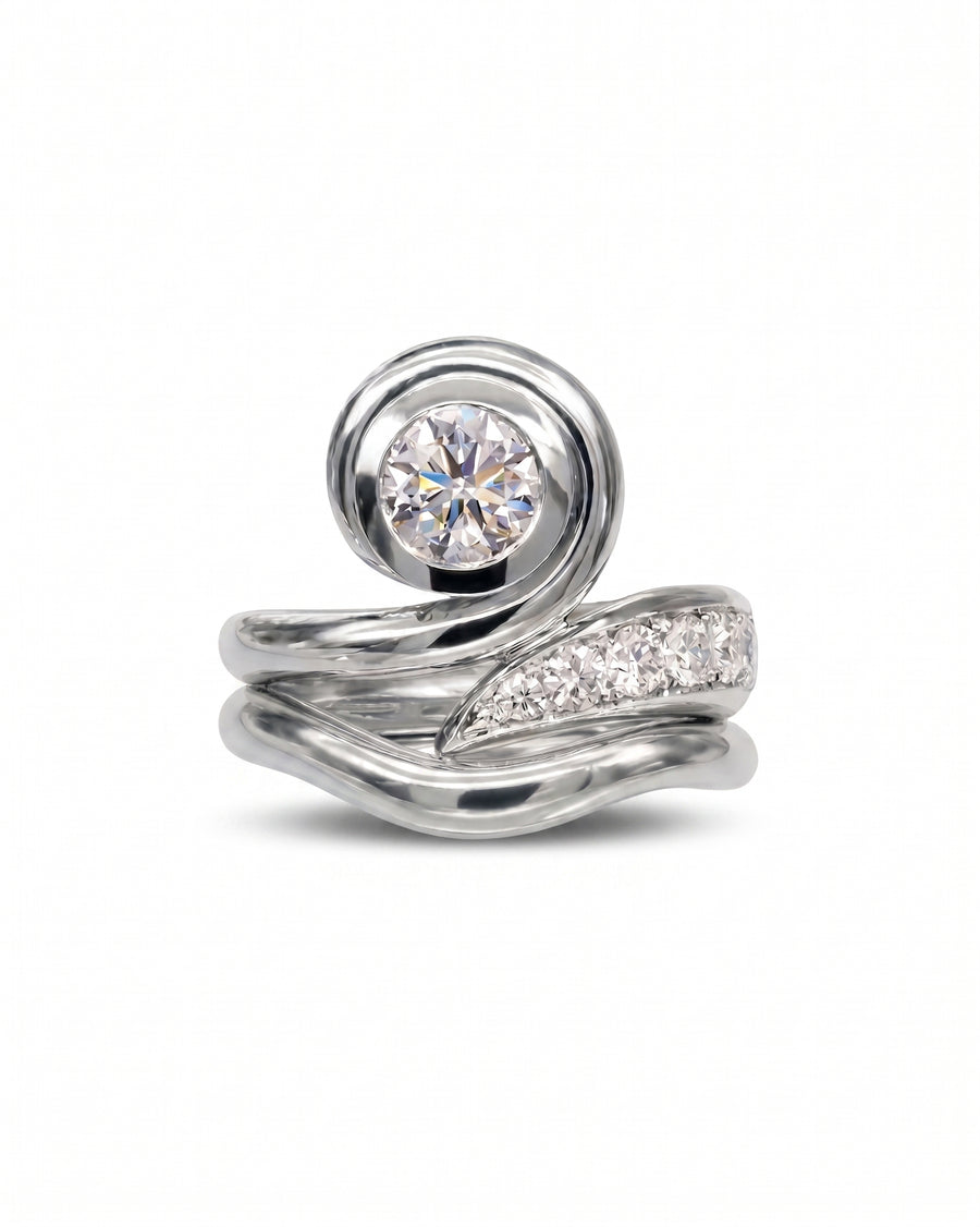 Platinum engagement ring with a round diamond and spiky organic design.