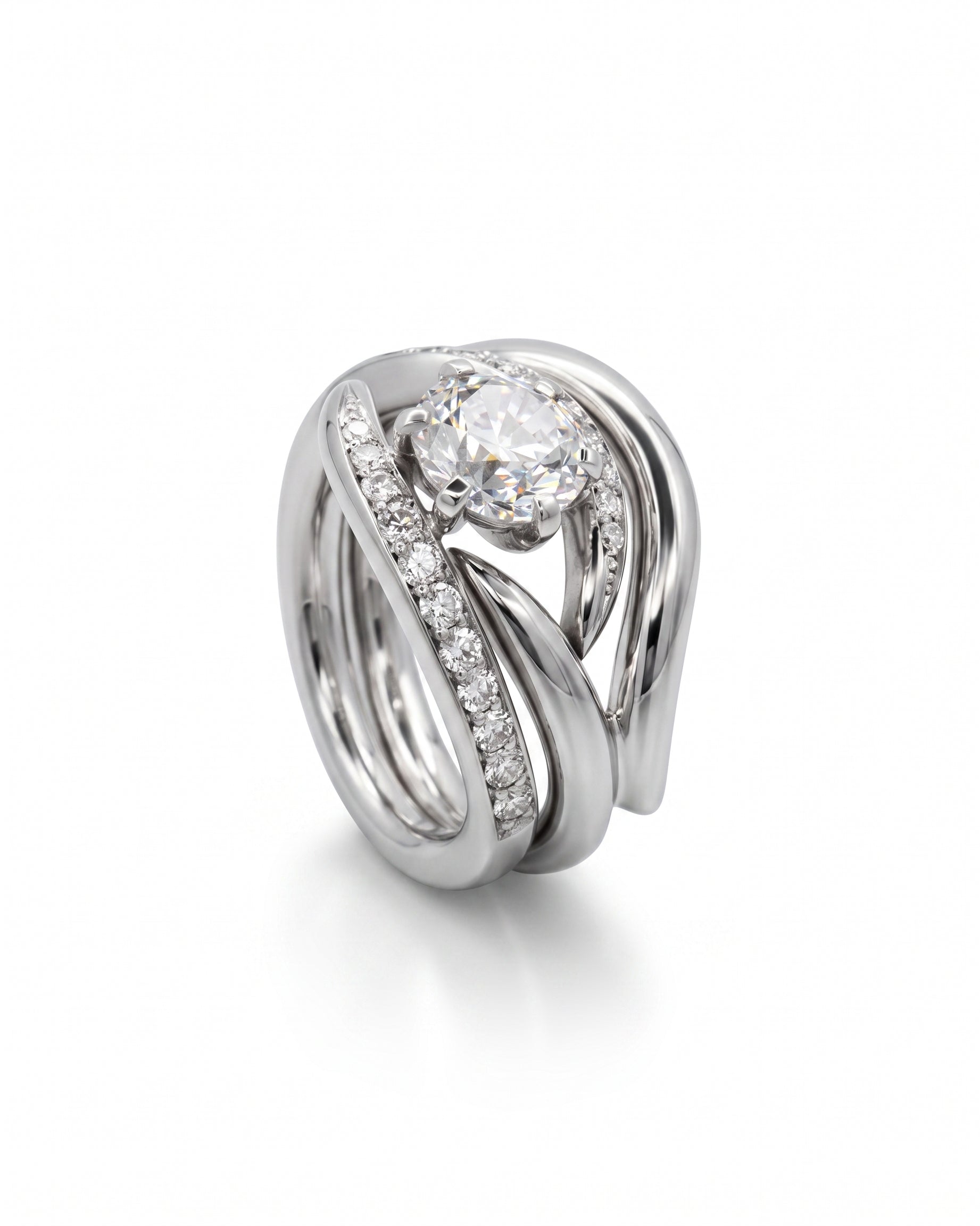 Platinum engagement and wedding band set with a round diamond and pavé diamonds.