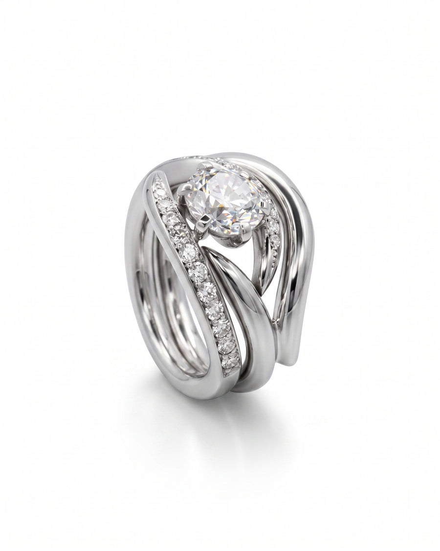 Platinum engagement and wedding band set with a round diamond and pavé diamonds.