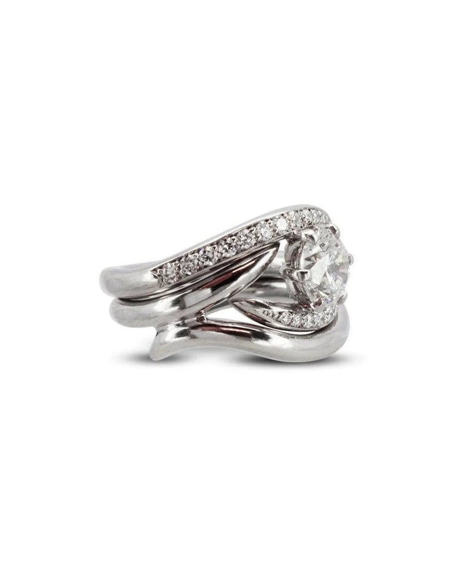 Platinum engagement and wedding band set with a round diamond and pavé accents.