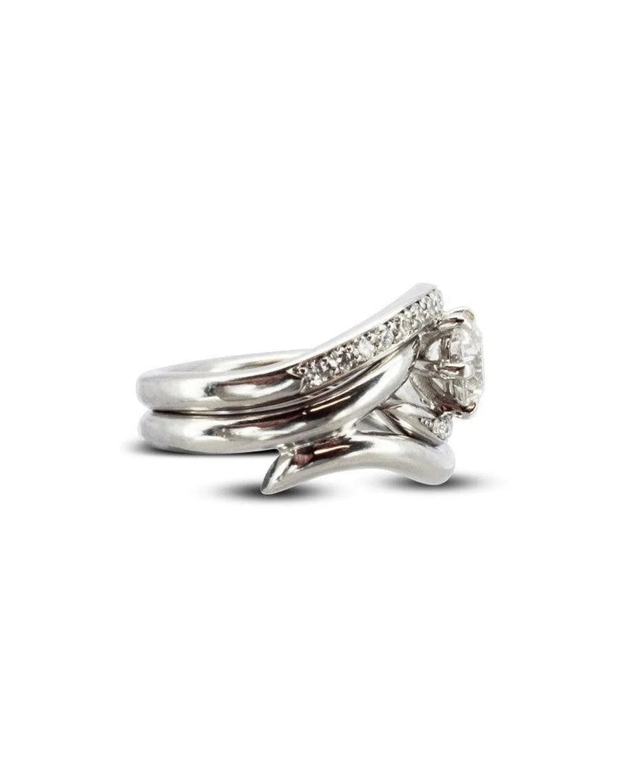 Platinum engagement and wedding band set with a round diamond and pavé accents.