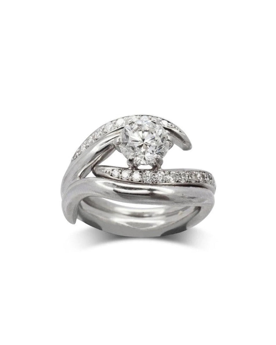 Platinum engagement and wedding band set with a spiky design and diamonds.