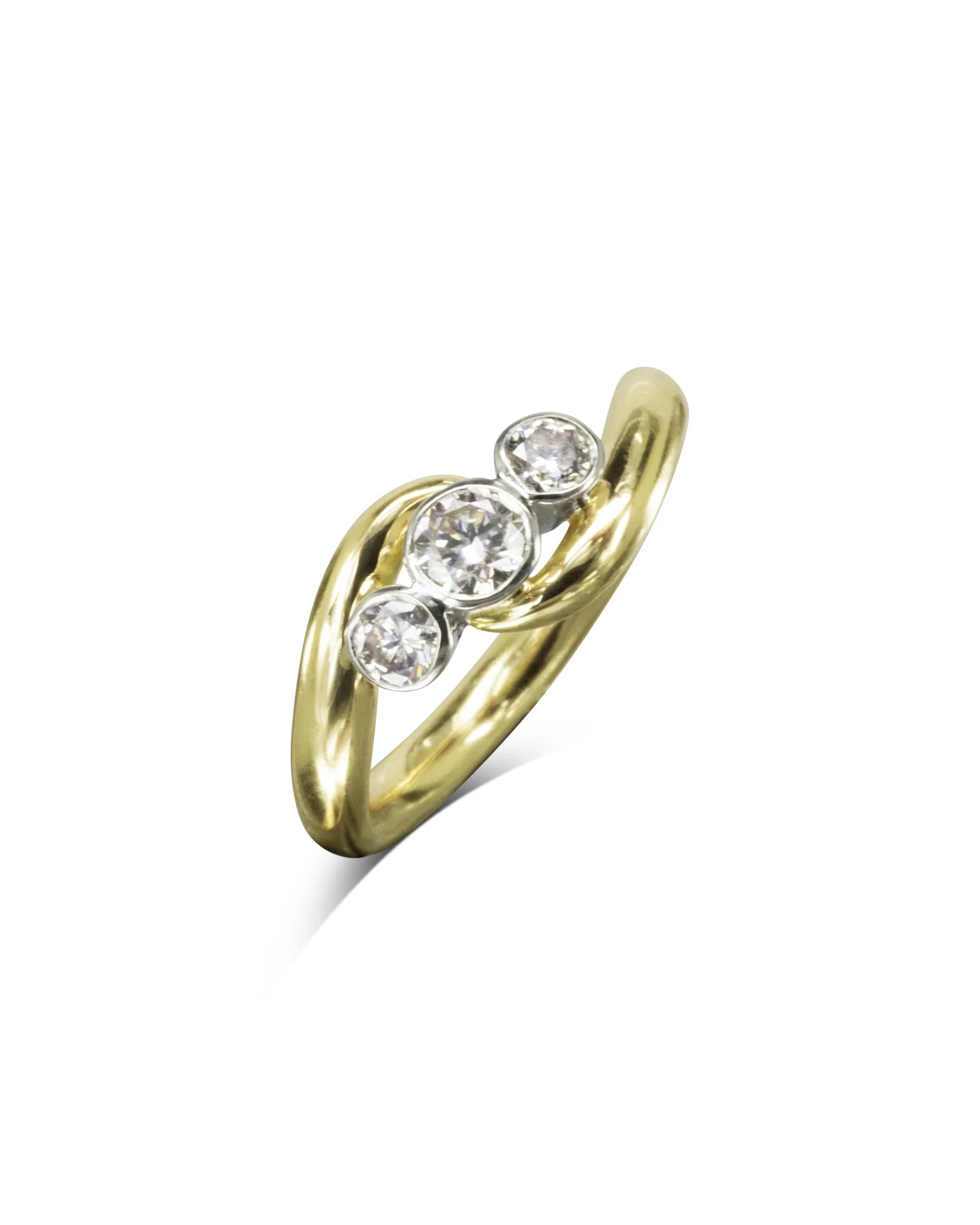 Gold and platinum trilogy diamond engagement ring with three round diamonds.