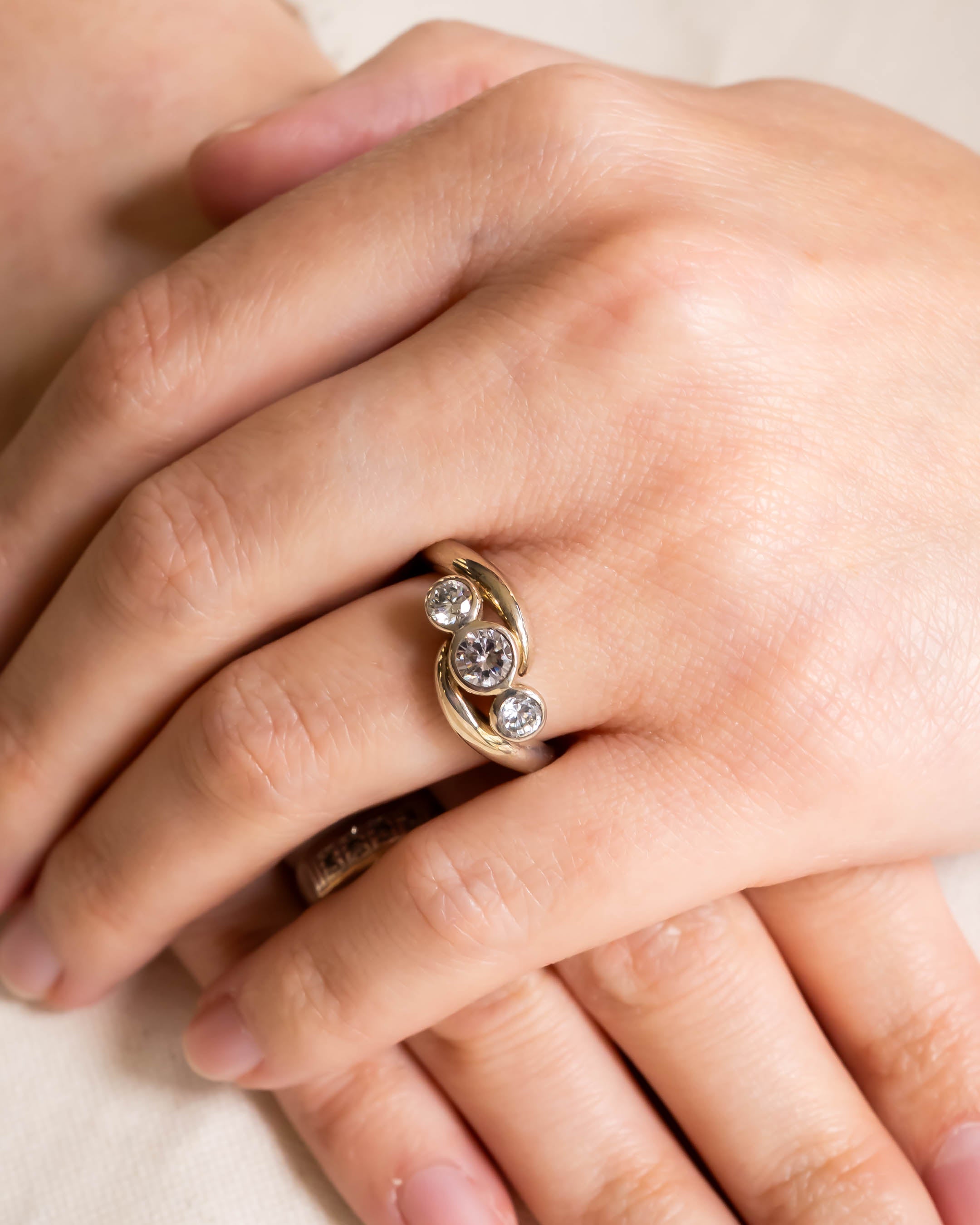 Platinum trilogy diamond engagement ring with spiky design.