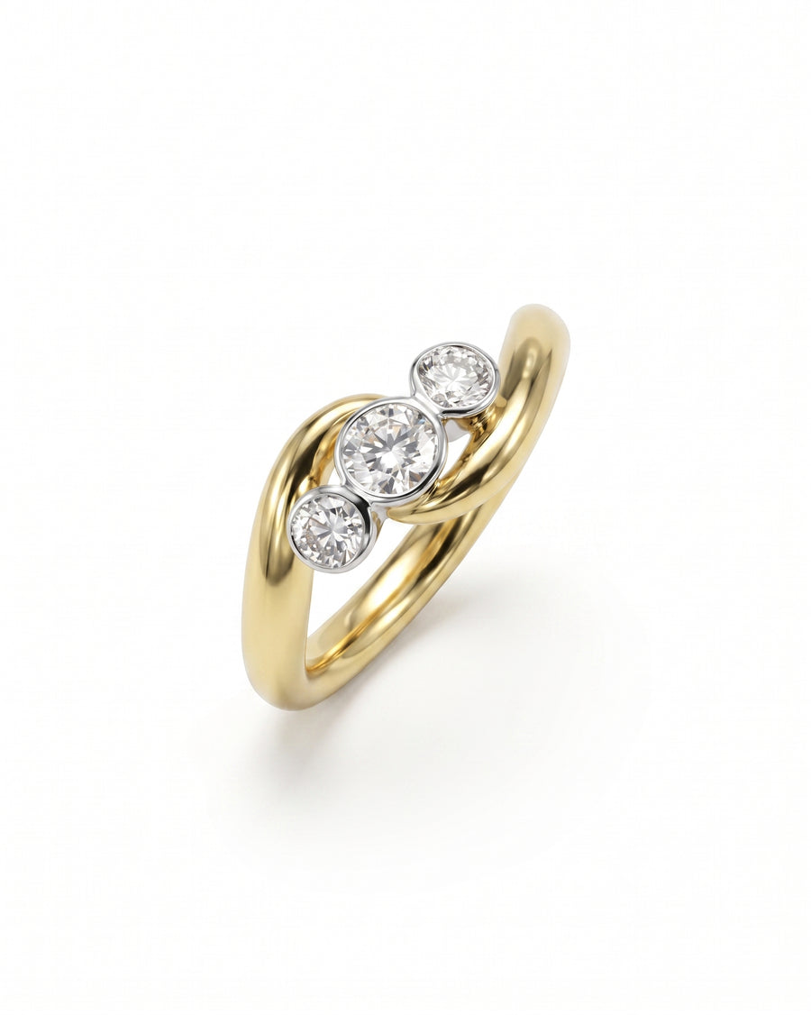 Gold engagement ring with three round diamonds in a spiky trilogy design.
