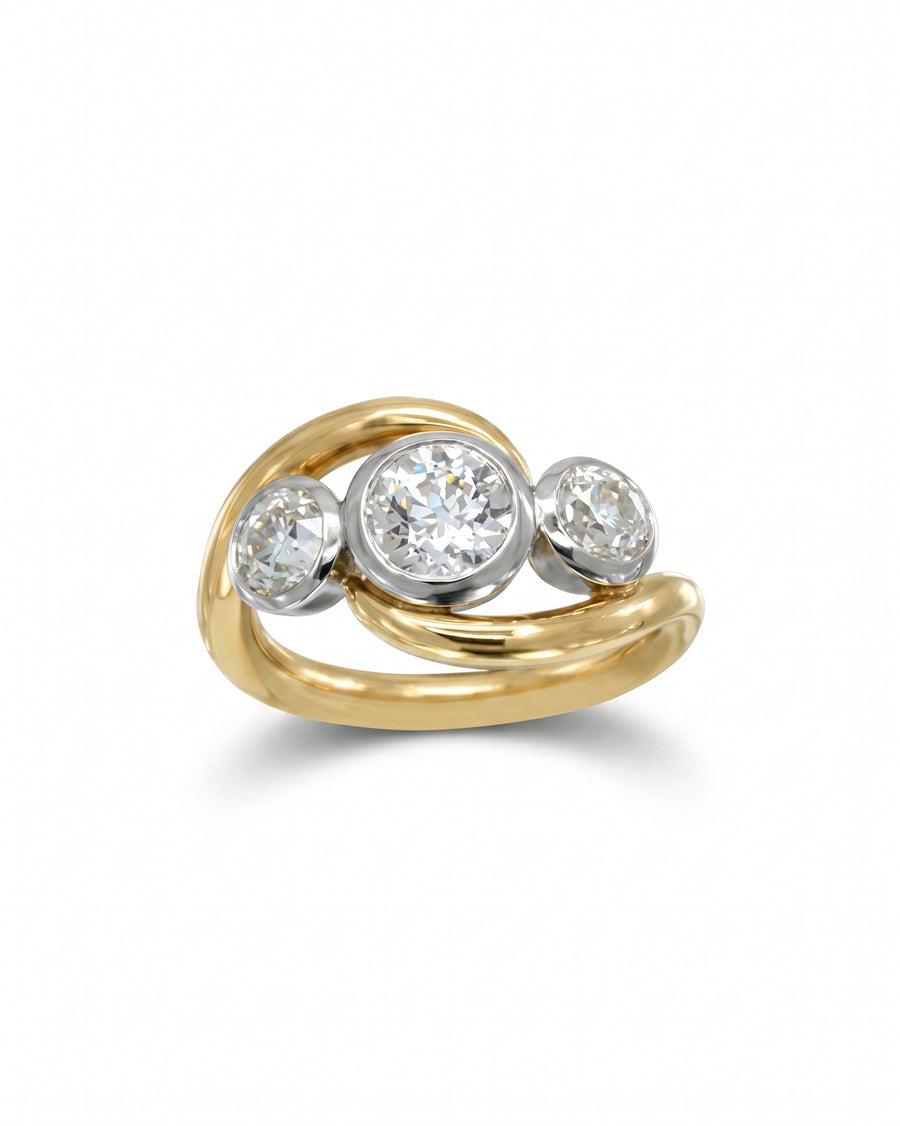 Gold and platinum engagement ring with three round diamonds.