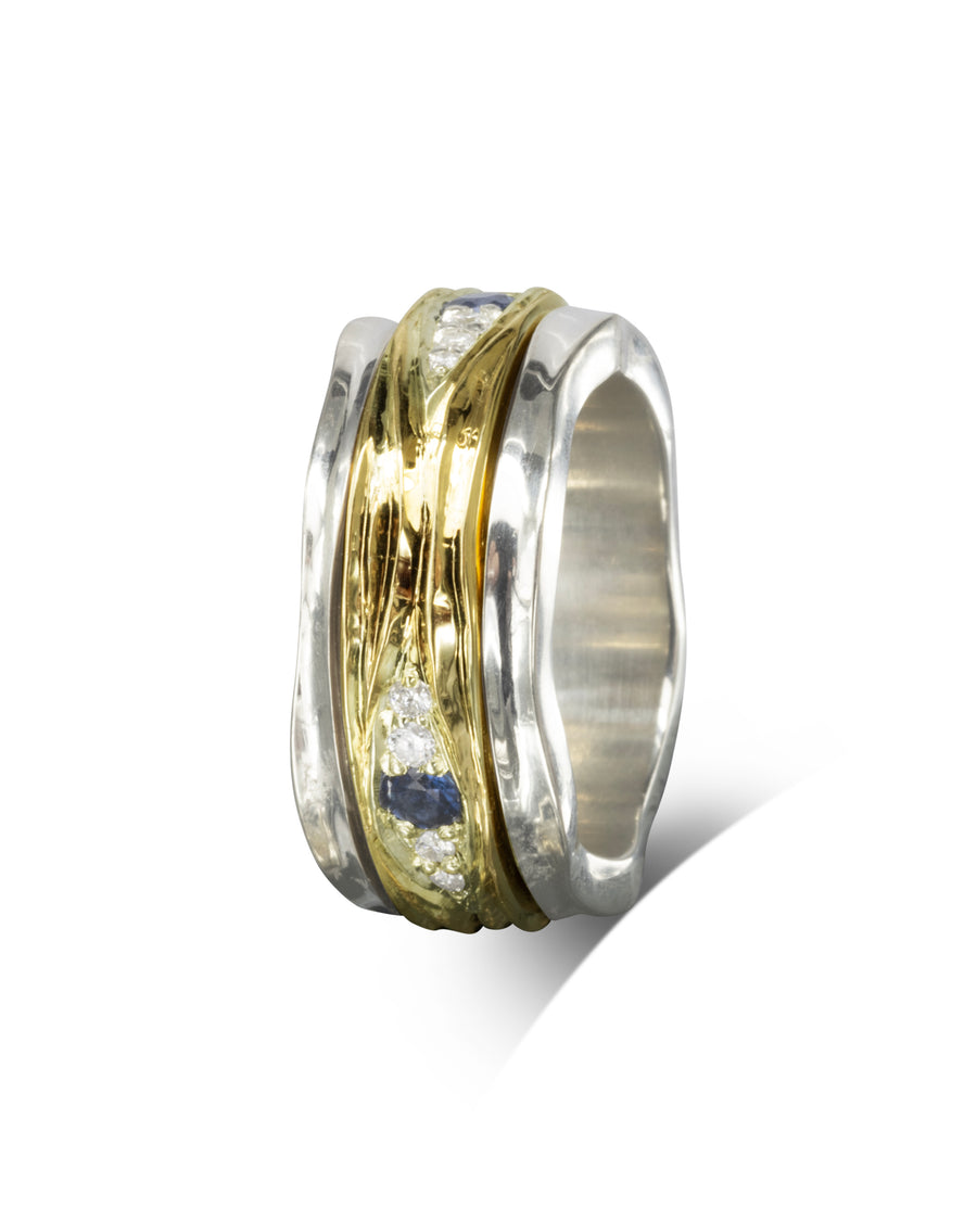 Silver and gold spinning ring with diamonds and blue sapphires.