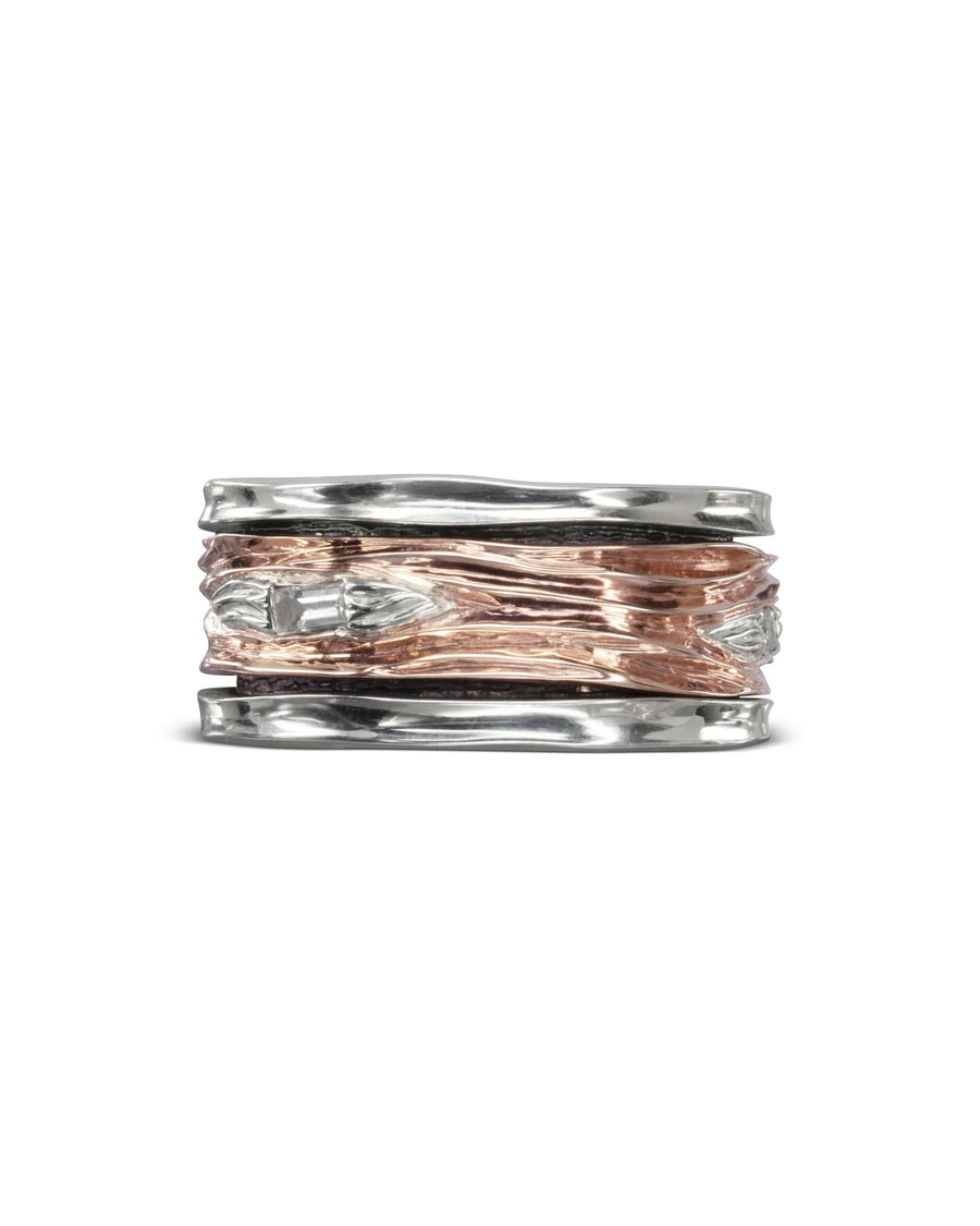 Rose gold and silver ring with a textured, wavy design.