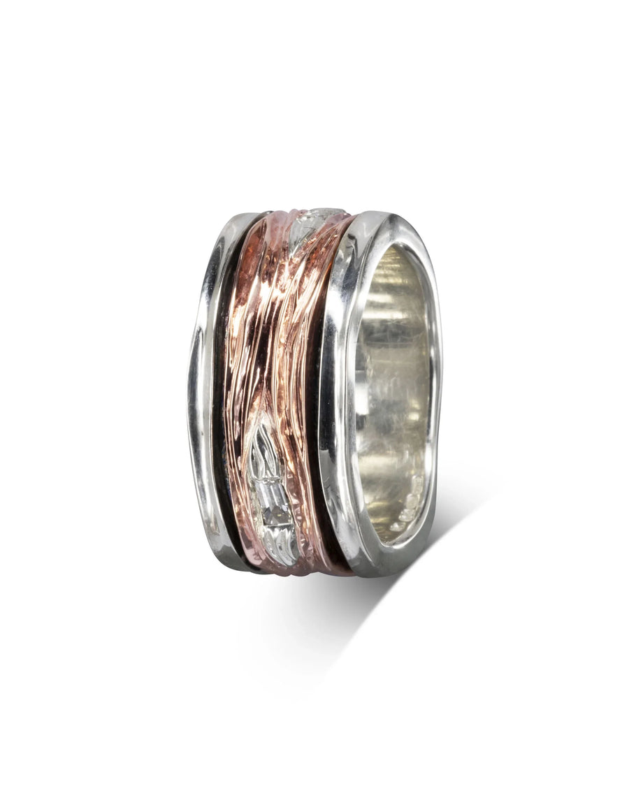 Rose gold and silver spinning ring with baguette cut diamonds.