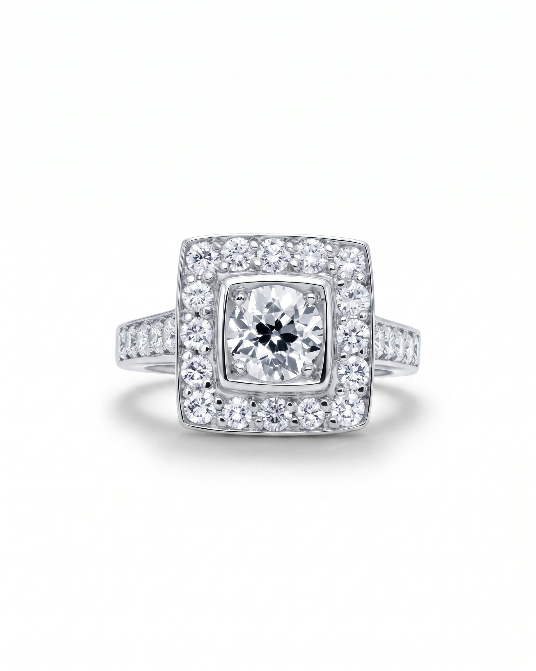 White gold square cluster engagement ring with diamond shoulders.