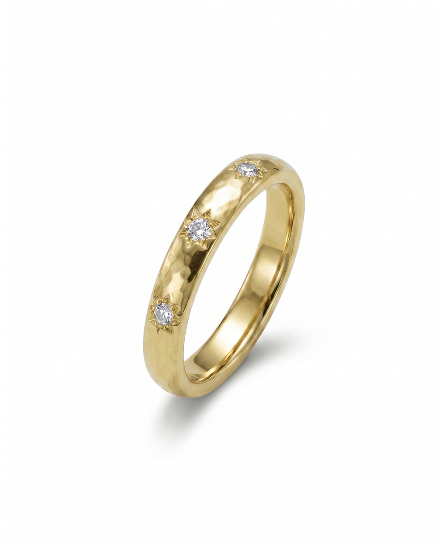 Gold ring with three star set diamonds.