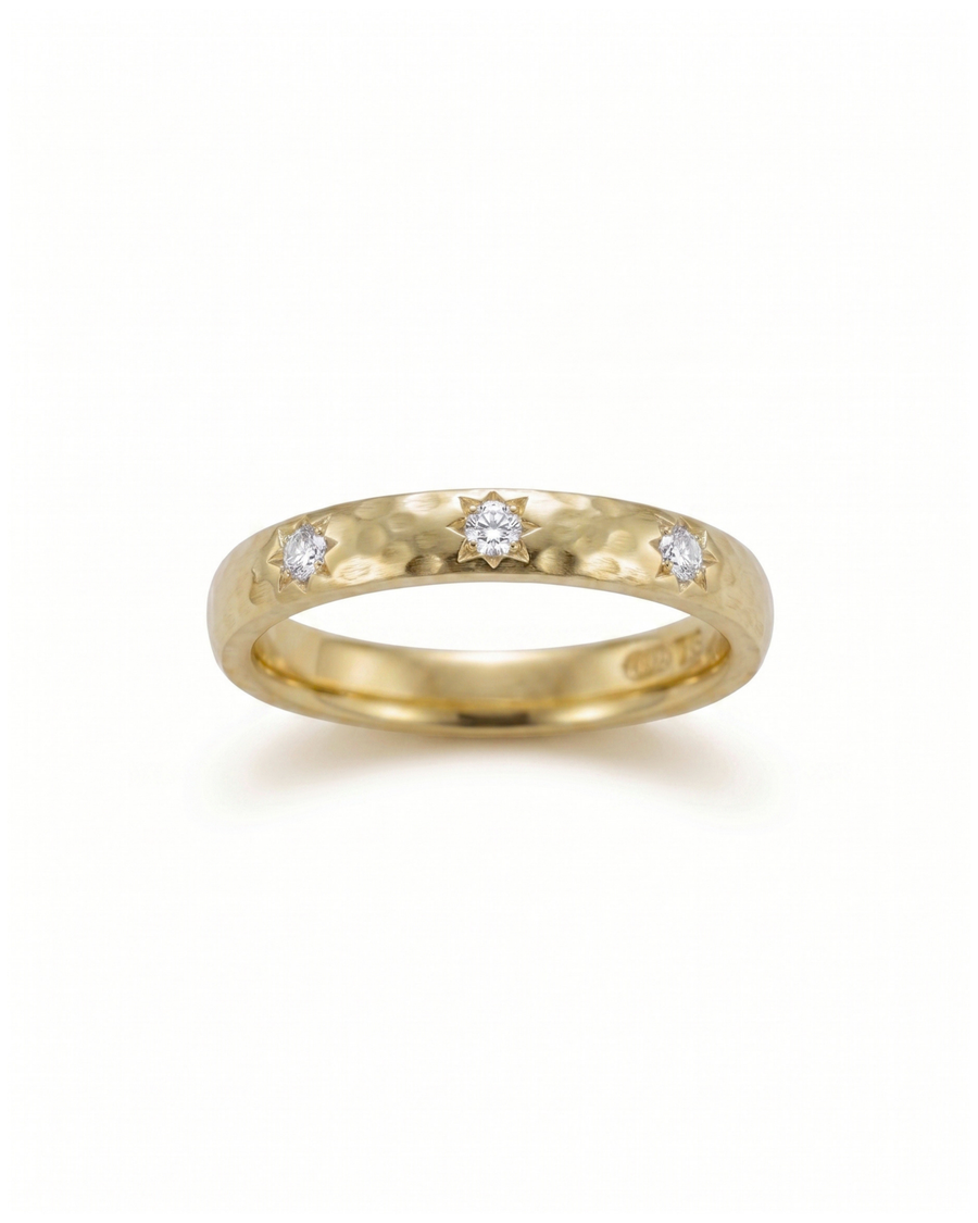 Gold hammered ring with three star-set diamonds.