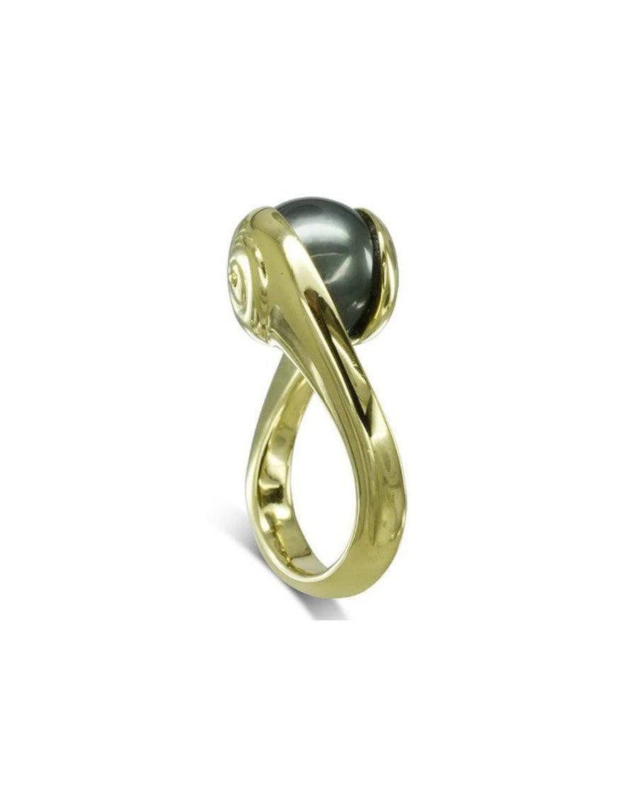 yellow gold ring featuring a suspended black Tahitian pearl and organic, sculptural design