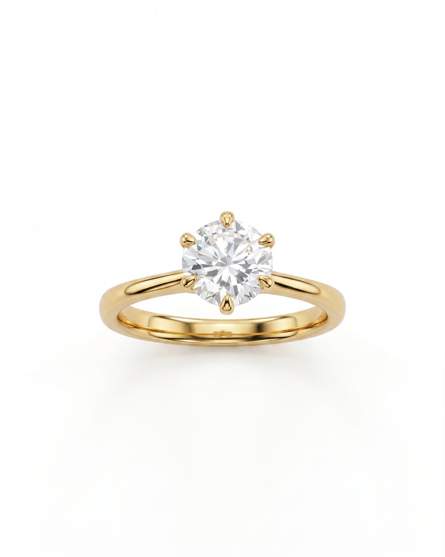 Gold solitaire engagement ring with a round cut diamond.