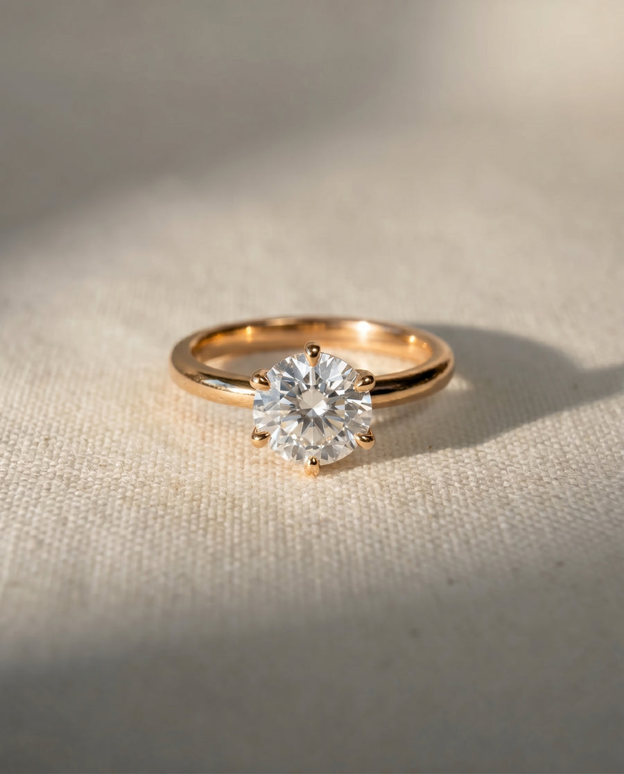 Rose gold solitaire engagement ring with a round cut diamond.