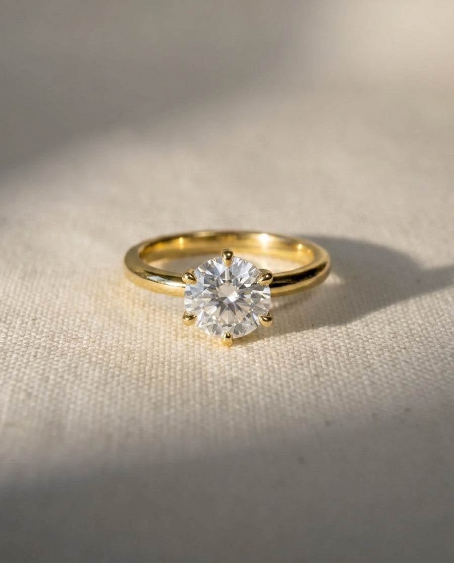 18ct yellow gold solitaire engagement ring with a round cut diamond.